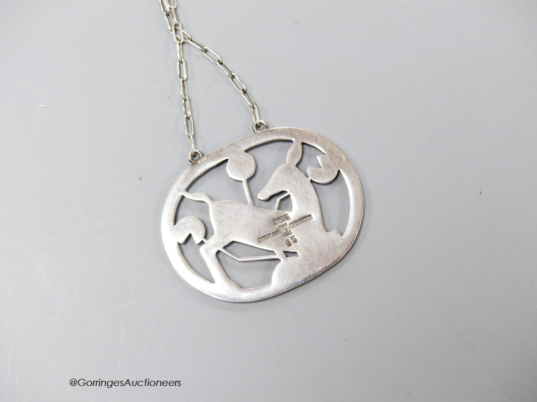 A George Jensen sterling 'kneeling deer' pendant necklace, design no. 95, 43mm, chain 58cm.